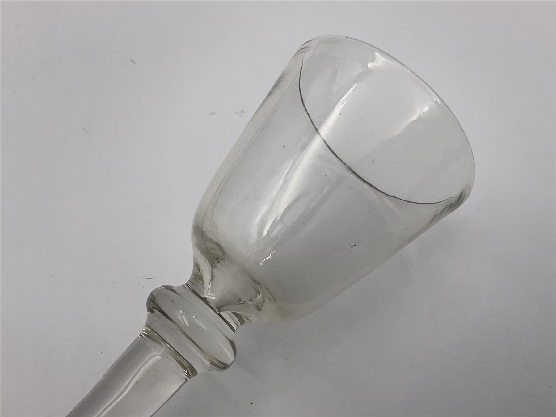 18th century wine glass, the trumpet shaped bowl upon tear drop stem and conical folded foot, H15.5cm, together with an 18th century cordial glass, the round funnel bowl on plain knopped stem and folded conical foot