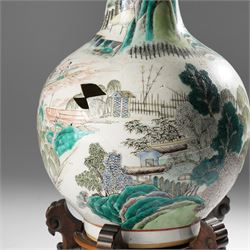 Chinese Kangxi period famille verte vase, the body finely painted with a continuous narrative scene of figures inside and out of a pavilion complex, beside a river, rocks and trees, character mark to base, raised upon a hardwood stand, overall H47cm
