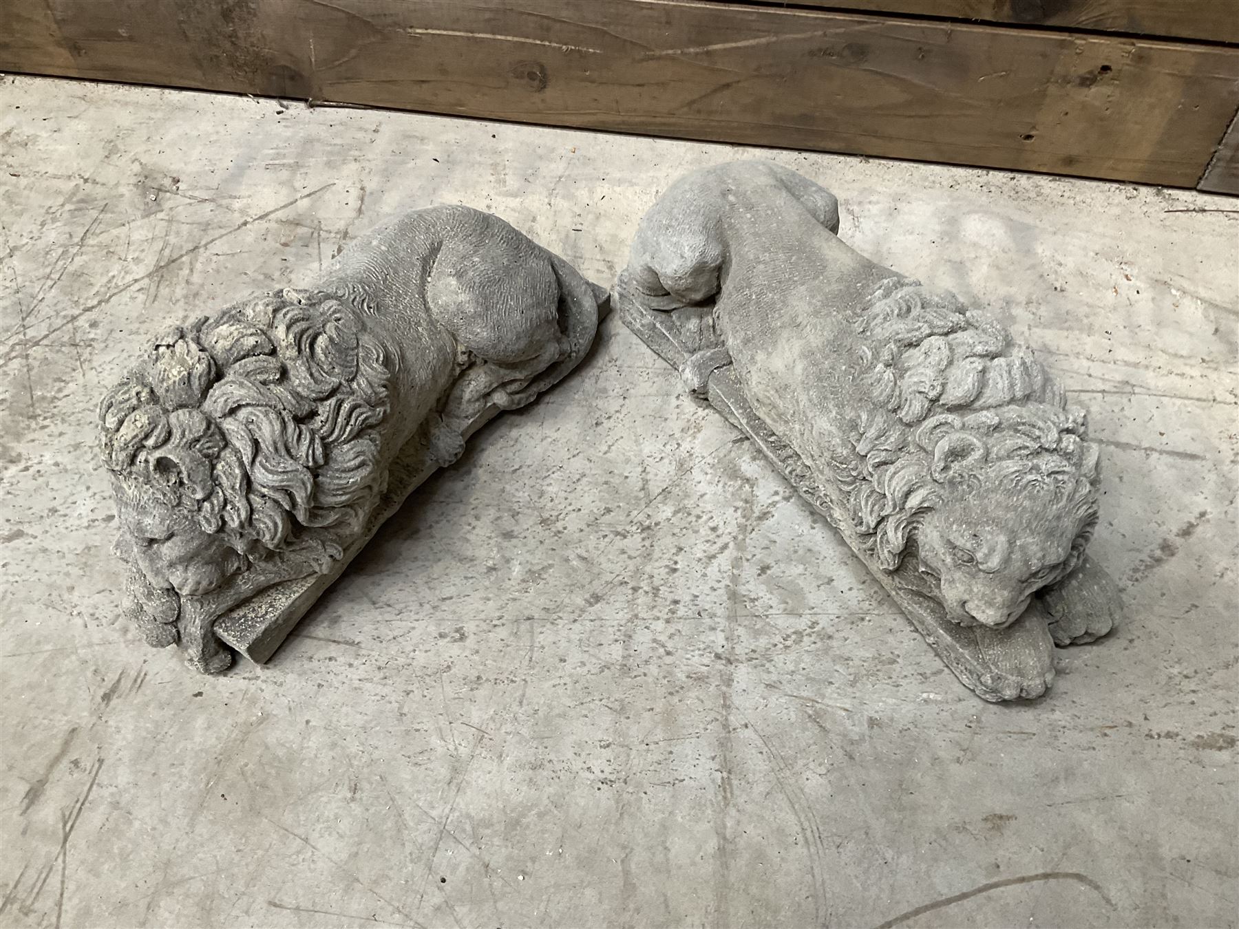 Pair of small cast stone sleeping Trafalgar Lions