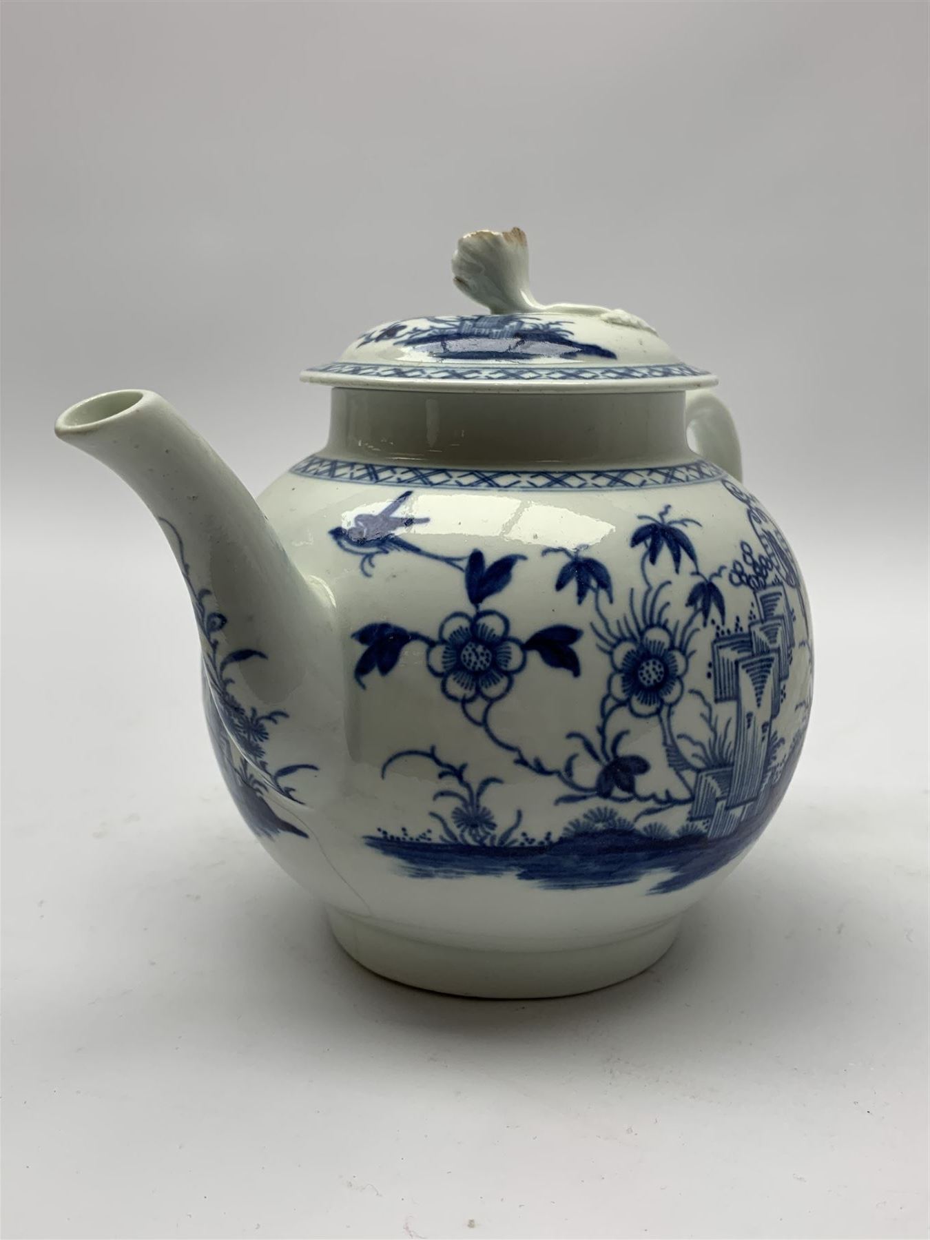 18th Century Worcester teapot, circa 1765-70, decorated in the Bird in the ring pattern, the cover with bud finial, with crescent mark beneath, H13cm, together with a Worcester coffee cup decorated in the same pattern, with crescent mark beneath, H6.5cm