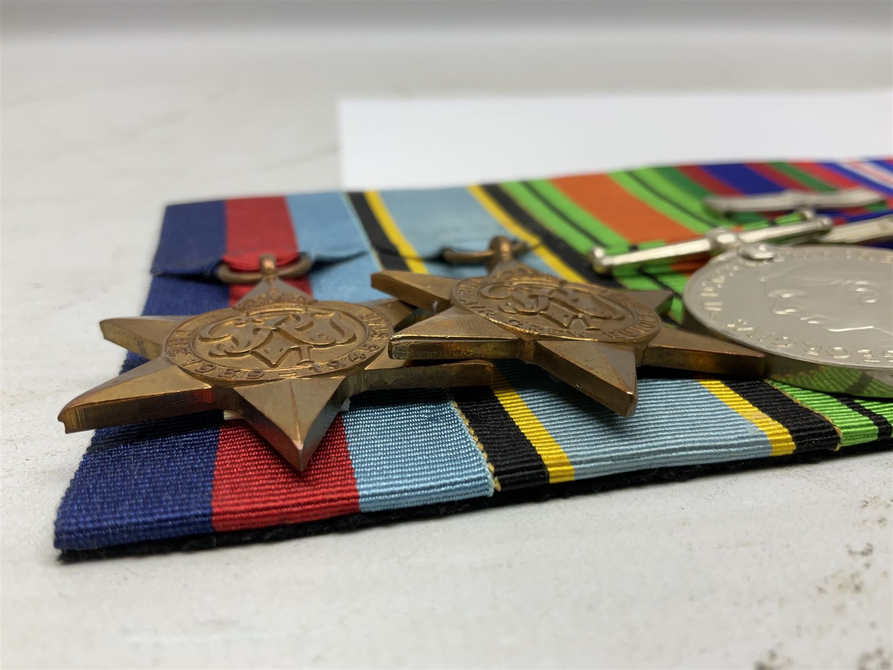 Group of five medals comprising 1939-1945 War Medal, Defence Medal, 1939-1945 Star, Air Crew Europe Star and Canadian Volunteer Service Medal with maple leaf clasp; all with ribbons and mounted on a display board