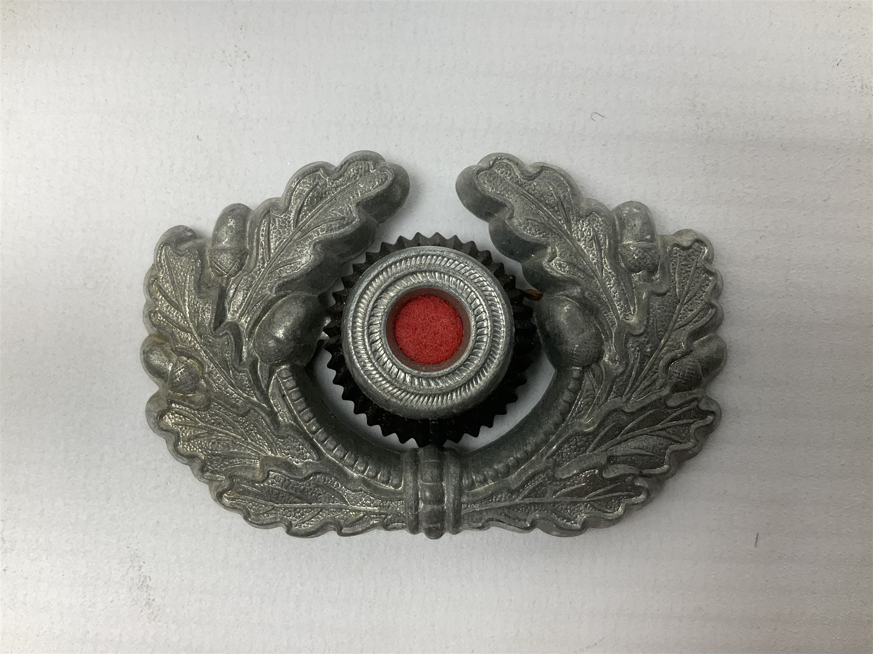 Five WW2 German peaked cap badges, four with double-pinned backs