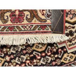 Small Persian Bidjar rug, the field decorated with floral Herati motifs, within floral design borders and guard stipes 