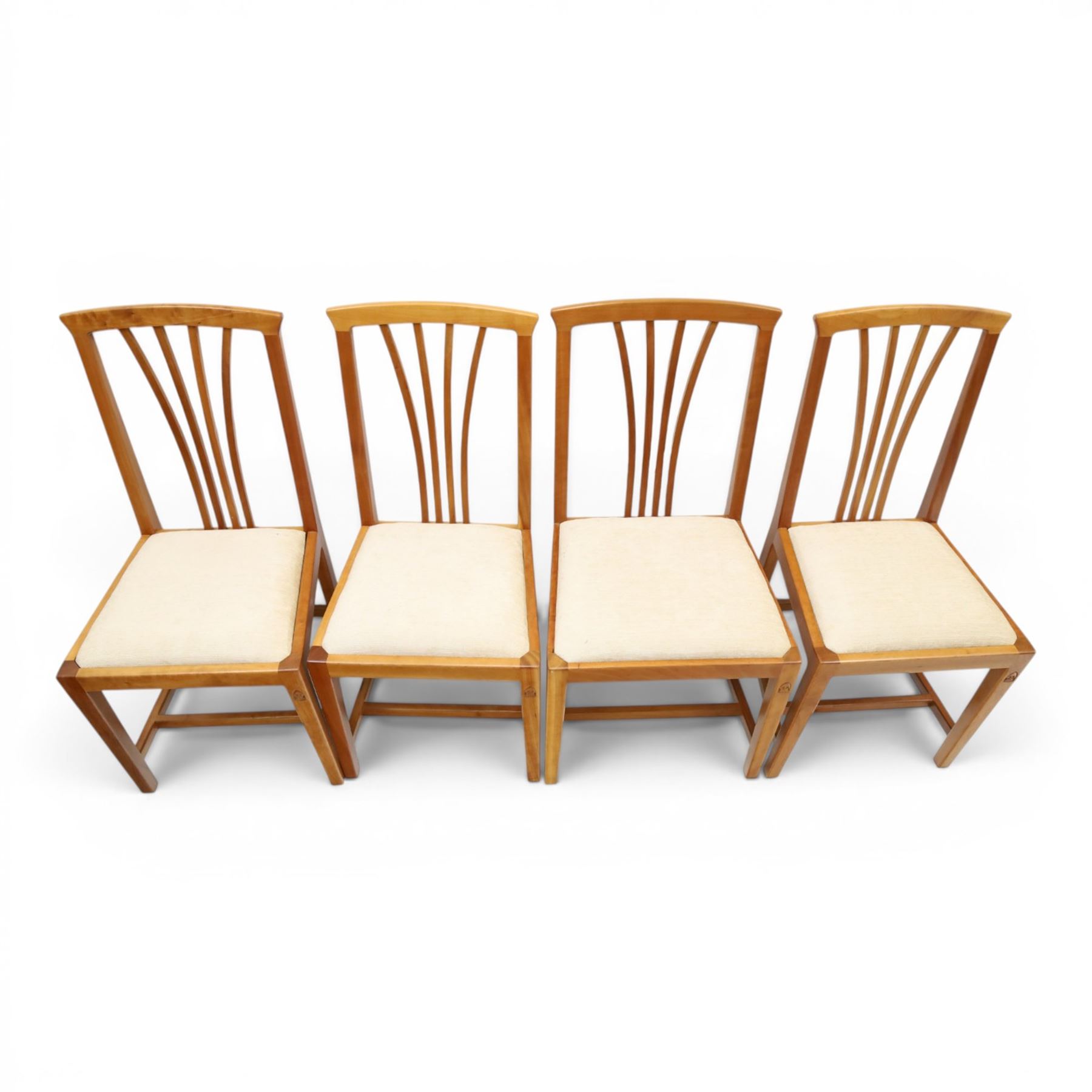 Knightman - set of nine cherrywood dining chairs, with fan splat backs and upholstered seats, raised on square legs joined by stretchers, comprising chairs of slight differing widths and one chair with turned front legs and orange upholstery and no Knight carving, the rest with recessed carved knight trademark, by Horace Knight of Old Mill Furniture, Balk near Thirsk 