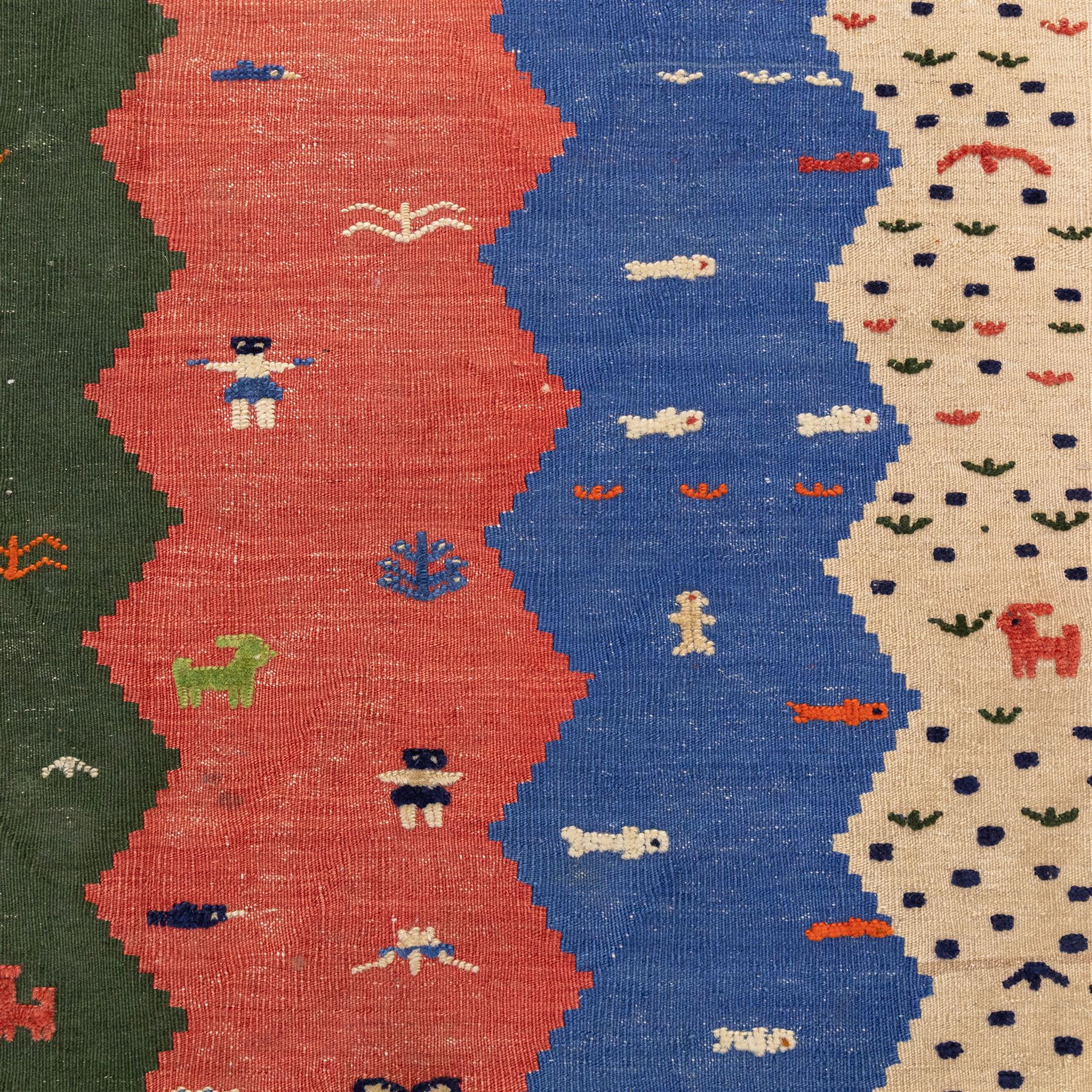 South West Persian Qahgai pictorial flatweave kilim, design arranged in a series of irregular vertical bands in shades of indigo, blue, madder red, pink, green, and ivory, each band filled with naïve pictorial and symbolic motifs of stylized human figures, sheep, goats, and birds