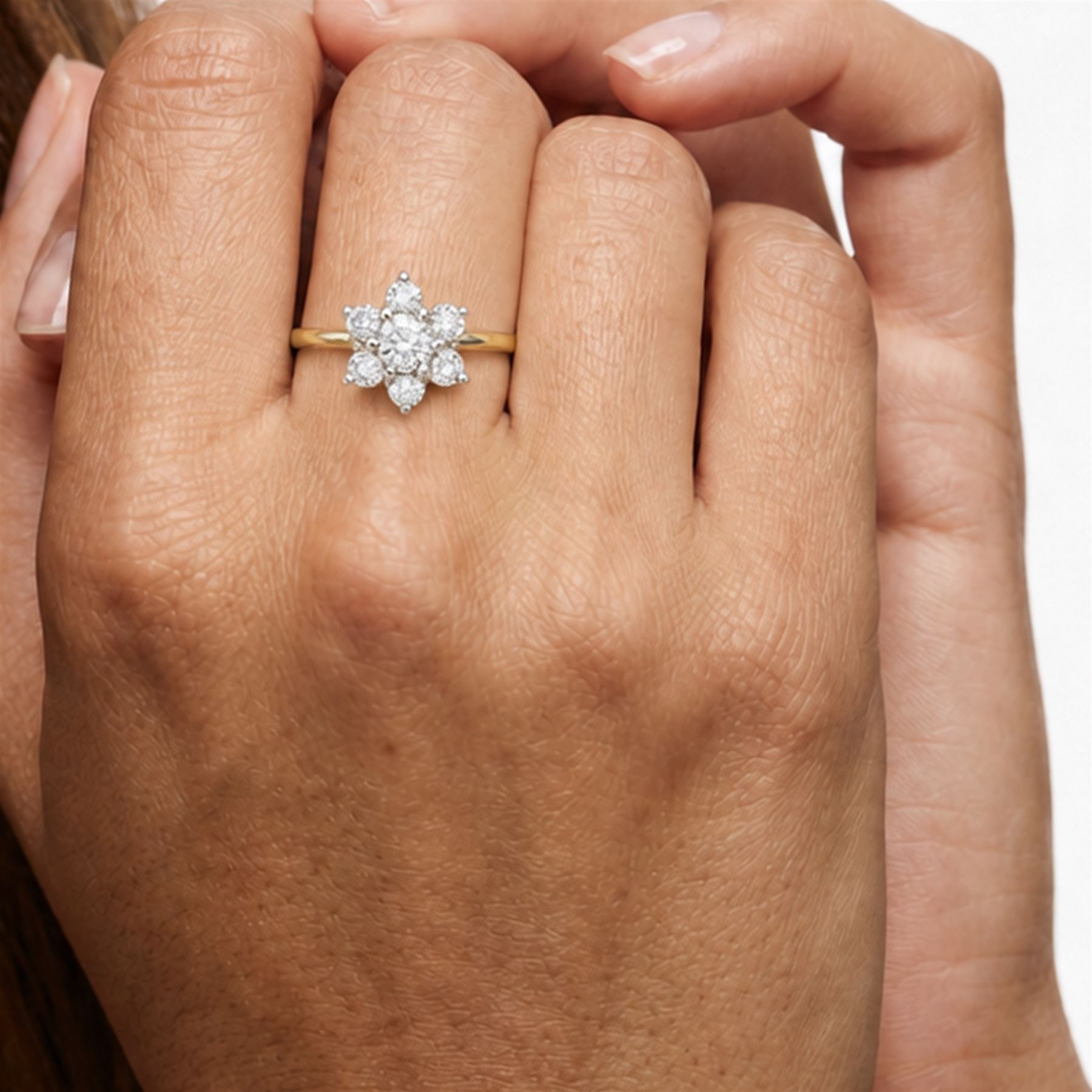 18ct gold diamond flower head cluster ring, principal round cut diamond of approx 0.55 carat, surrounded by six round brilliant cut diamonds, hallmarked, total diamond weight 1.15 carat