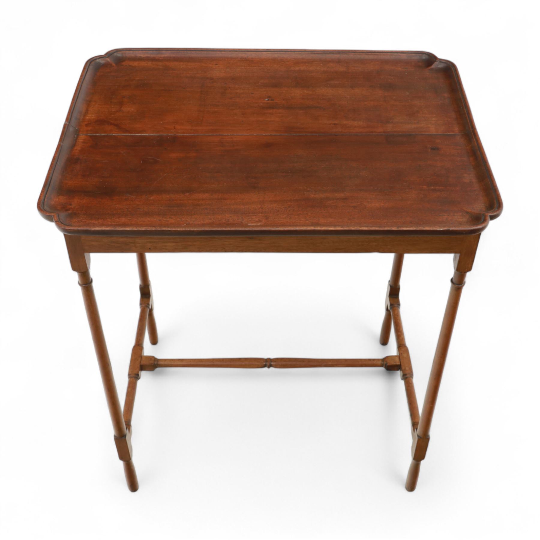 Early 20th century mahogany butler’s tray table, rectangular dished top with shaped corners, raised on turned faux bamboo legs with stretchers
