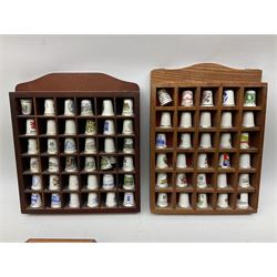 Quantity of thimbles to include ceramic and metal examples, housed in five wood display cases, including one glazed box, together with a quantity of loose and boxed examples