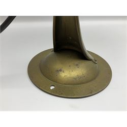 Arts & Crafts Jesson, Birkett & Co, brass table lamp or wall light, designed by Thomas Birkett, the tapering stem with adjustable ball pivot supporting a conical shade with tapering final with ball terminal, upon a circular domed base pierced for wall mounting, shade positioned upright overall H57cm

Often misattributed to Arthur Stansfield Dixon for Birmingham Guild of Handicraft, this particular lamp was designed by Thomas Birkett.
In the late 1890's Birkett worked as a metalwork at the Birmingham Guild, before later joining the Faulkner Bronze Company which went on to become Jesson, Birkett & Co in 1904. The lamp features in lighting catalogues from the firm under the model no E490.

