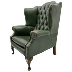 Georgian style wing back armchair, upholstered in deeply buttoned green hide, studded detail