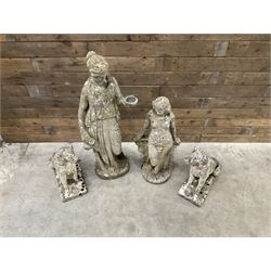 Pair of cast stone garden dogs and 2 female figures,