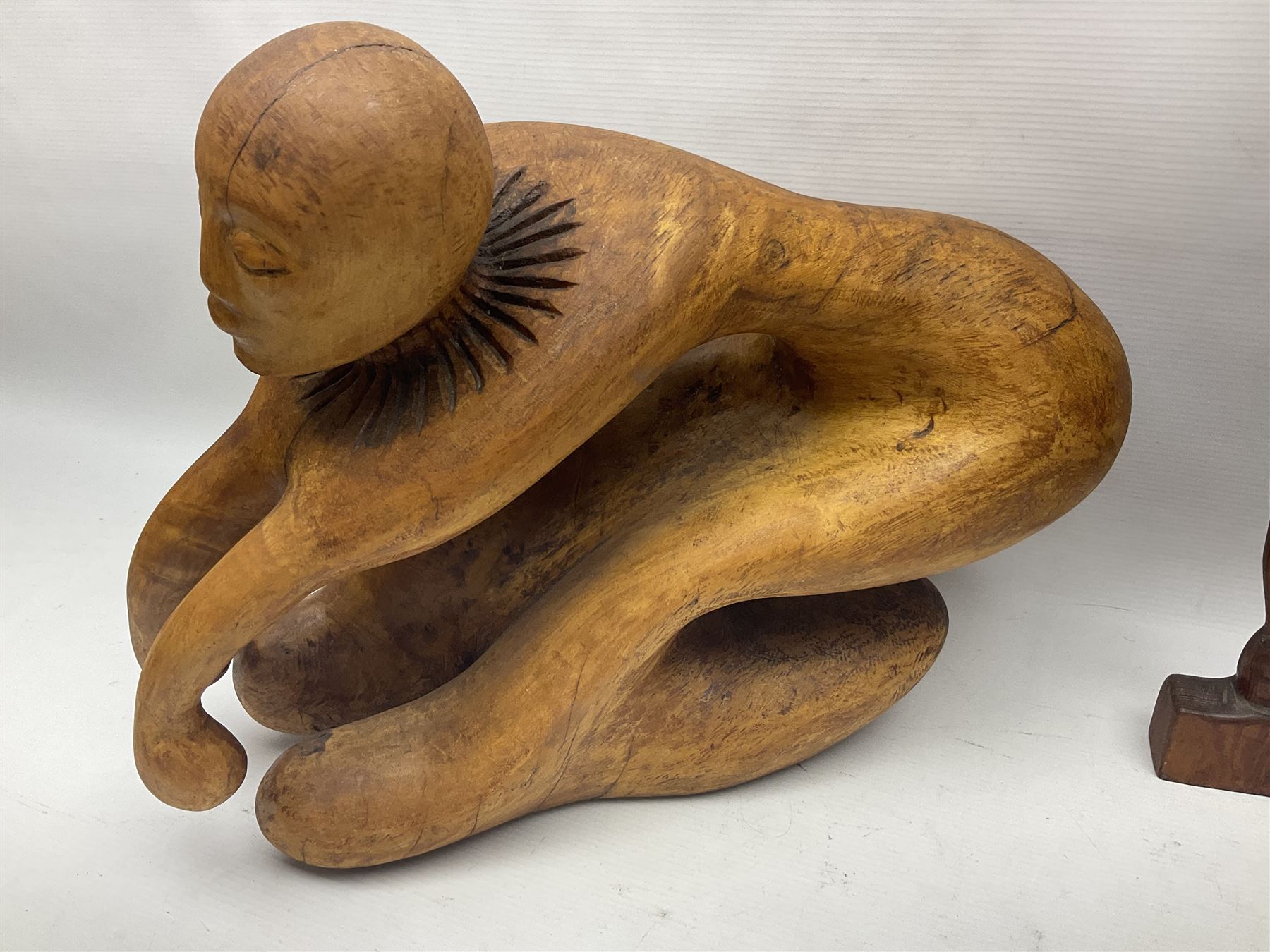 Helen Skelton (British 1933 – 2023): Three carved wooden abstract sculptures, each modelled as a a figure, tallest H52cm. Born into an RAF family in 1933 in Kent and travelled the world extensively during her childhood. After settling in Bridlington, Helen immersed herself in painting, textiles, and wood sculpture, often inspired by nature's beauty. Her talent was showcased in a one-woman show at Sewerby Hall and recognised with the sculpture prize at Ferens Art Gallery in 2000. Sadly, Helen’s daughter passed away from cancer in 2005. This loss inspired Helen to donate her sculptures to Marie Curie upon her passing in 2023.