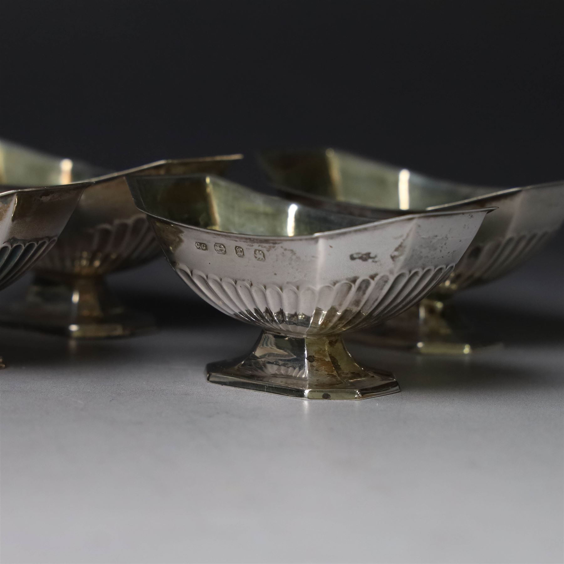 Set of four late Victorian silver open salts, of octagonal part fluted form, with four clam shell spoons, hallmarked Colen Hewer Cheshire, Birmingham 1896, salts H4cm, contained within fitted case