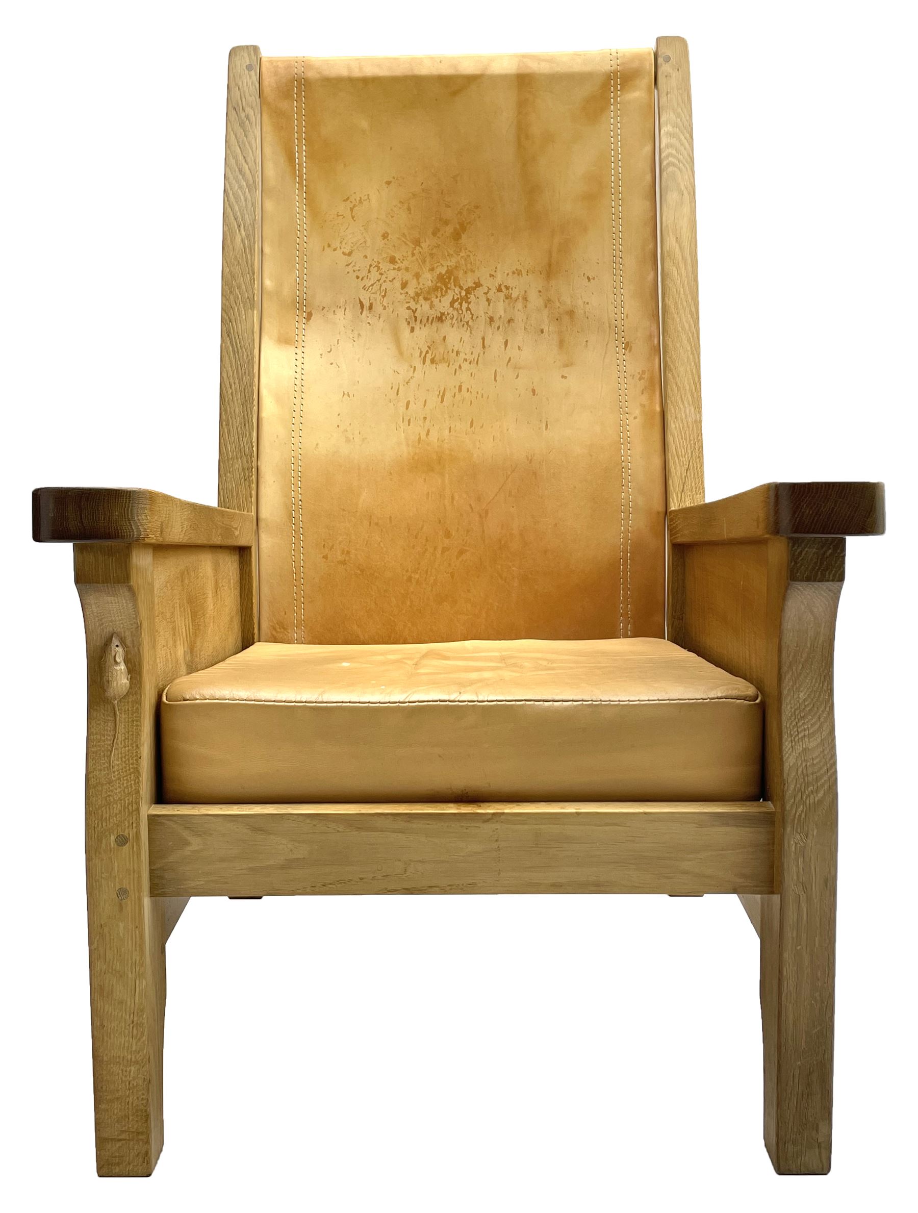'Mouseman' oak smokers armchair, panelled sides, slung tan leather back and upholstered seat cushion, by Robert Thompson of Kilburn