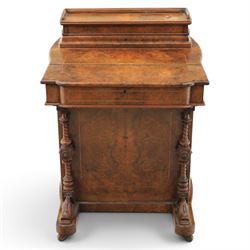 Victorian burr walnut Davenport, with hinged stationary top and slope, pull out writing surface with tooled green leather inset top, carved and turned front supports, flanked by two cupboard doors, raised on castors 