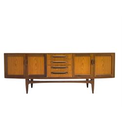 Victor B Wilkins for G-Plan - mid-20th century teak 'Fresco' sideboard, fitted with four central drawers, flanked by two double panelled cupboards, raised on tapered supports