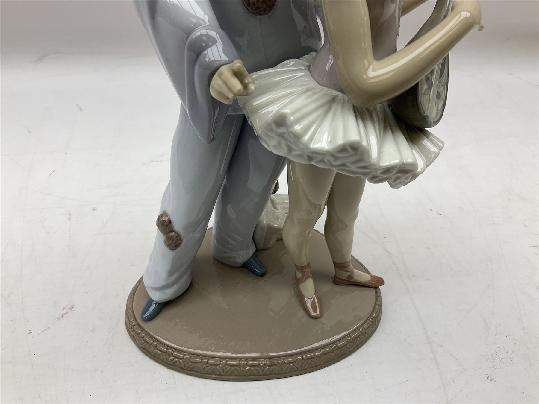 Lladro figure, Minstrel's Love, modelled as a couple entertaining, the lady in ballerina costume playing the lute and the gent stood behind her in jester type dress, sculpted by Rafael Lozano, with original box, no 5821, year issued 1991, year retired 1993, H31cm