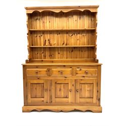 Pine farmhouse dresser with three drawers and three cupboards, and two tier plate rack