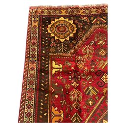 Persian Azerbaijani rug, red ground field with central stylised flower head medallion which repeats in each corner, decorated all over with stylised plant and bird motifs, repeating guarded border with geometric design 