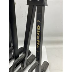 Three folding tubular guitar stands marked TGI and Giraffe; Orange Crush 10 guitar amplifier; Kinsman multi-coloured adjustable metal music stand; two guitar straps marked Fender; and quantity of cables