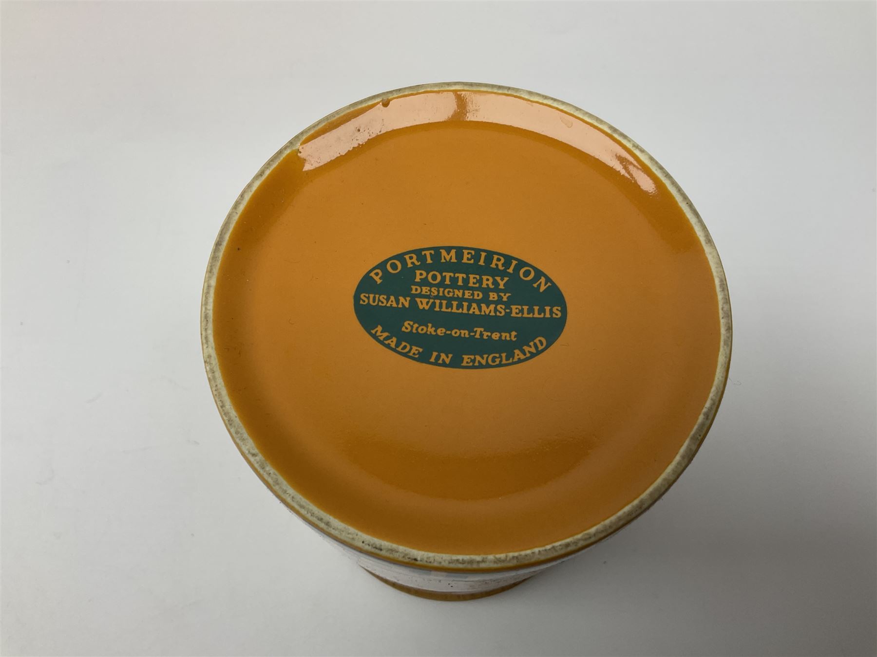 Four Portmeirion storage jars with Greek key pattern on an orange ground, together with Tams Ware tea service and other ceramics