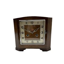 A 1930’S Art Deco 8-day striking mantle clock in a rectangular oak case on raised feet, with a corresponding square dial, hours in Arabic numerals and minute track, with pierced silvered hands, chrome winding collets and a square chrome bezel, striking the hours and half-hours on a coiled gong. 
With pendulum.


