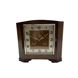 A 1930’S Art Deco 8-day striking mantle clock in a rectangular oak case on raised feet, with a corresponding square dial, hours in Arabic numerals and minute track, with pierced silvered hands, chrome winding collets and a square chrome bezel, striking the hours and half-hours on a coiled gong. 
With pendulum.

