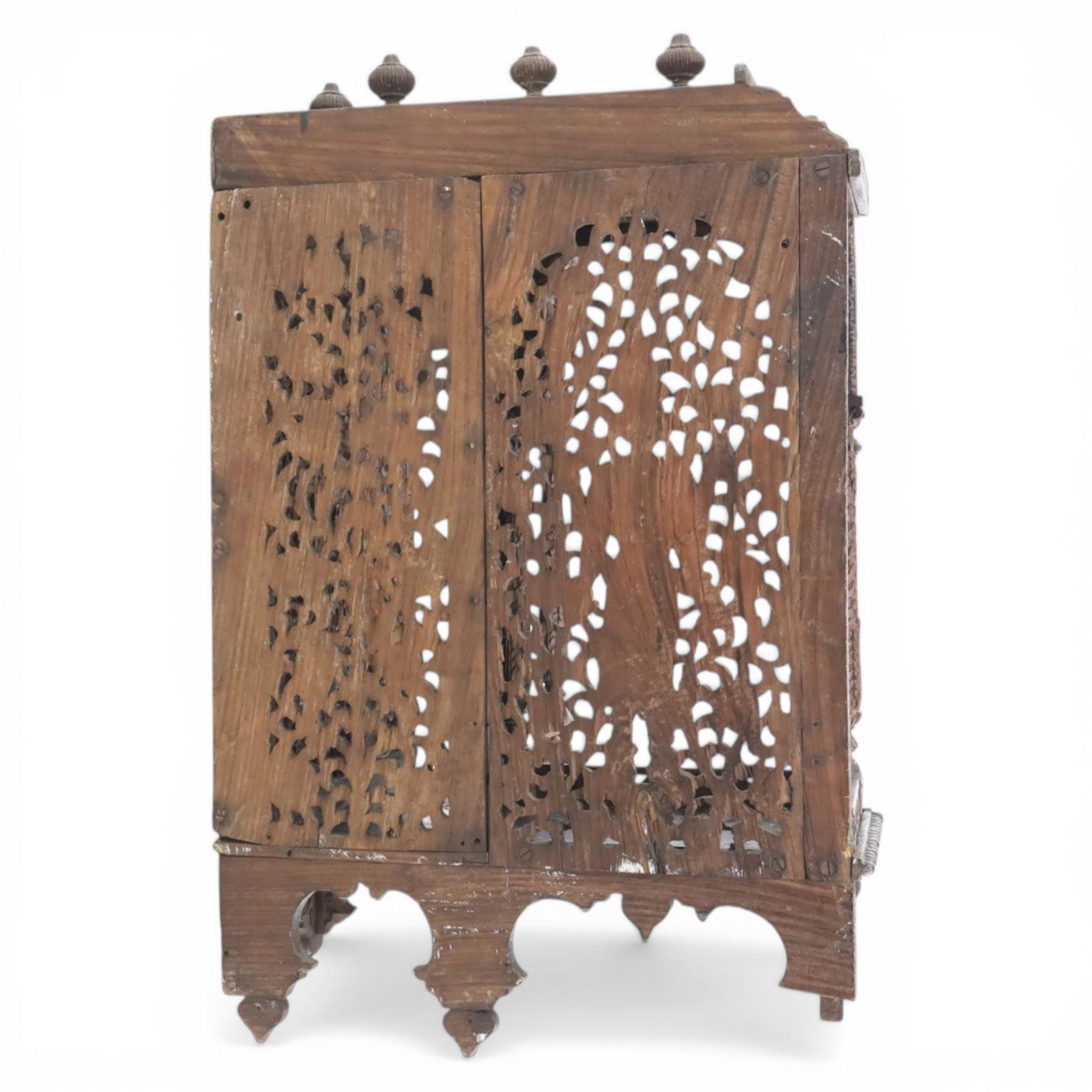 20th century Indian carved hardwood corner shelf, the tiered pagoda form with pierced and carved foliate panels centred by figural carving, supported by turned and carved columns, with shaped brackets and pendant finials