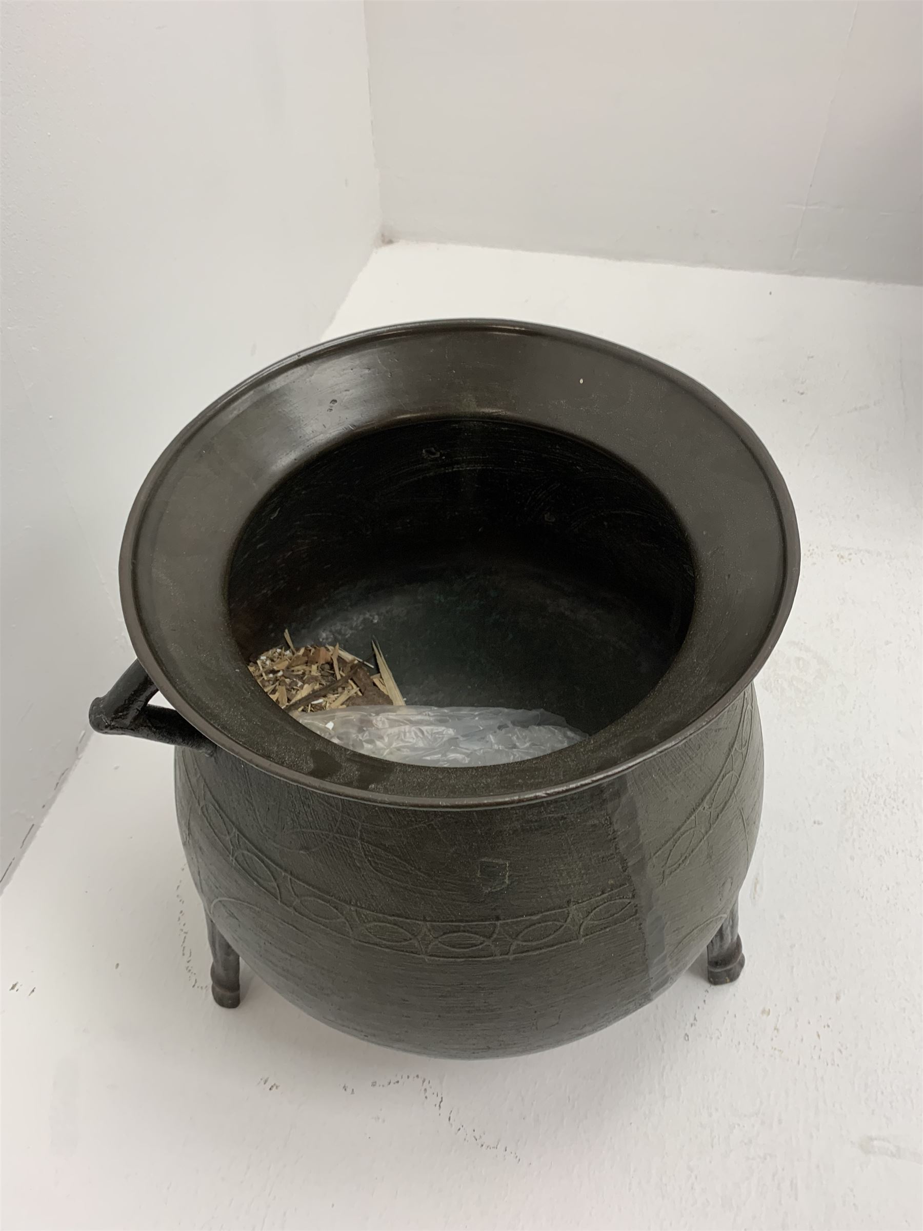 Late 17th/early 18th century bronze cauldron, of bellied form with flared rim and twin angular handles, upon three ribbed outswept feet, detailed with a decorative band beneath four arc founder's mark for John Sturton (I or II) of South Petherton, Somerset and a capital 'I', H40cm, rim D36cm