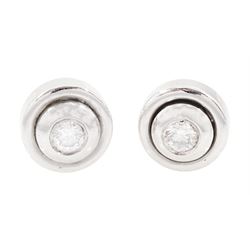 Pair of 18ct white gold diamond earrings, each stud bezel set with a single round brillian...