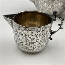 Late Victorian silver bachelors three piece tea service, comprising bullet shaped teapot, open sucrier and milk jug, each engraved with monogram surrounded by birds upon and amidst a blossoming vine, the teapot with scroll capped curved wooden handle and wooden finial to cover, hallmarked Wakely & Wheeler, London 1890, teapot including handle H12cm, sucrier H5.5cm 