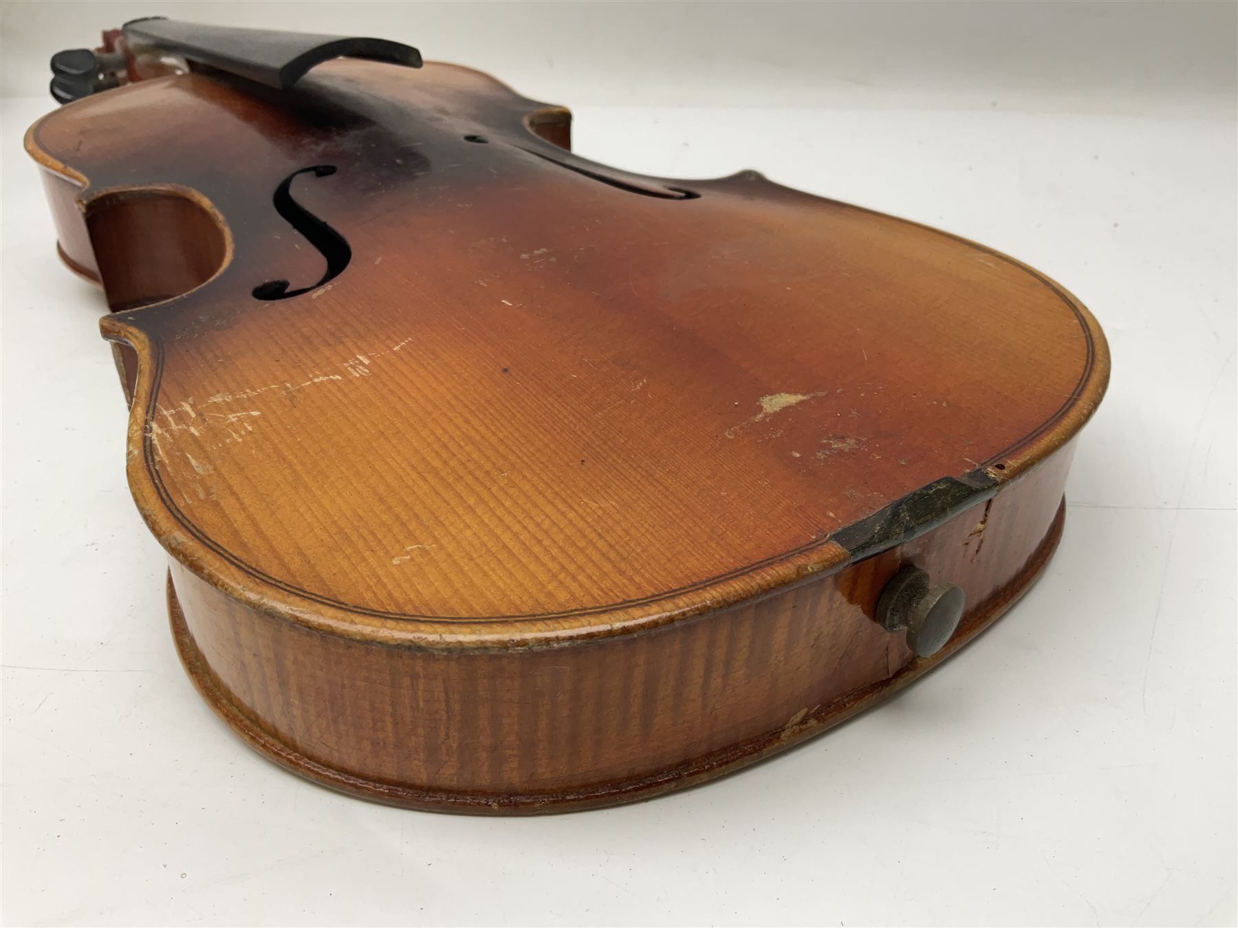 Czechoslovakian violin c1920 with 36cm two-piece maple back and ribs and spruce top, bears label 'Copy of Antonius Stradivarius Made in Czechoslovakia' L59cm; in carrying case; 1950s Czechoslovakian violin; and 195os Czechoslovakian three-quarter size violin; both cased (3)