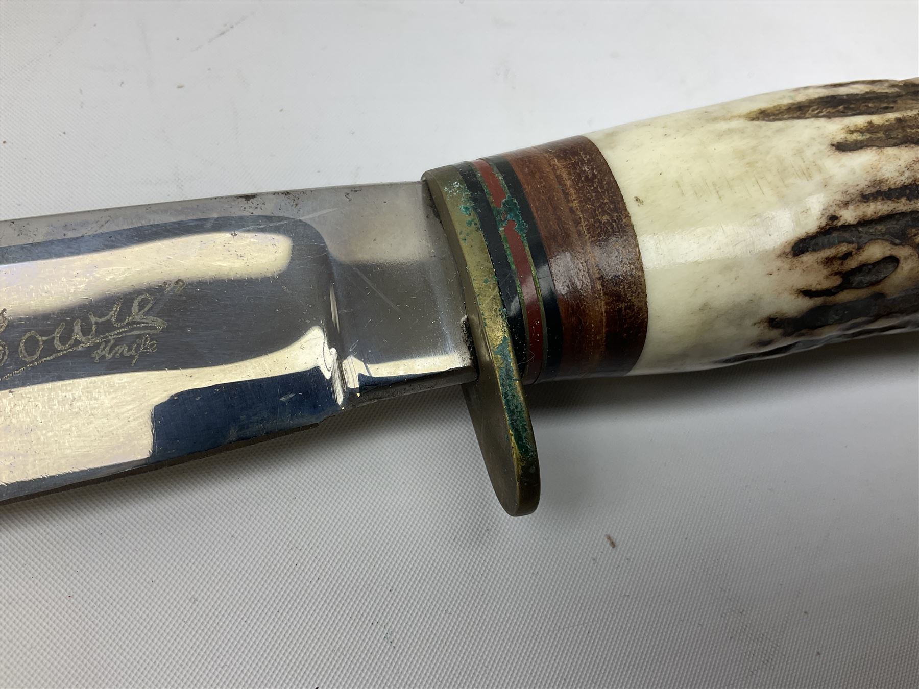 Bowie knife by J. Nowill & Sons Sheffield England Est. AD1700,  with 17.5cm steel blade, brass cross-piece, antler grip and alloy pommel; in leather sheath L32cm overall