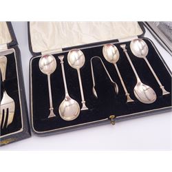 Set of six 1920s silver coffee spoons and a pair of sugar tongs, hallmarked William Suckling Ltd, Birmingham 1928, together with a similar set of spoons and tongs, hallmarked William Suckling Ltd, Birmingham 1928 and a set of six 1920s silver cake forks, hallmarked Cooper Brothers & Sons Ltd, Sheffield 1927, all within fitted cases