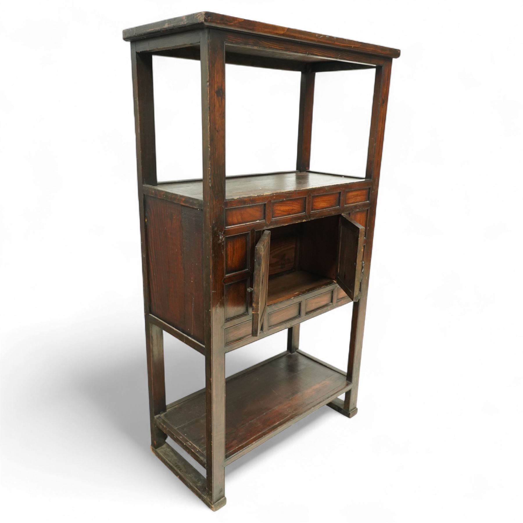 20th century Korean stained pine and elm cabinet, rectangular top over central panelled cupboard doors with metal ring handles, framed by geometric mouldings, open shelf above and below
