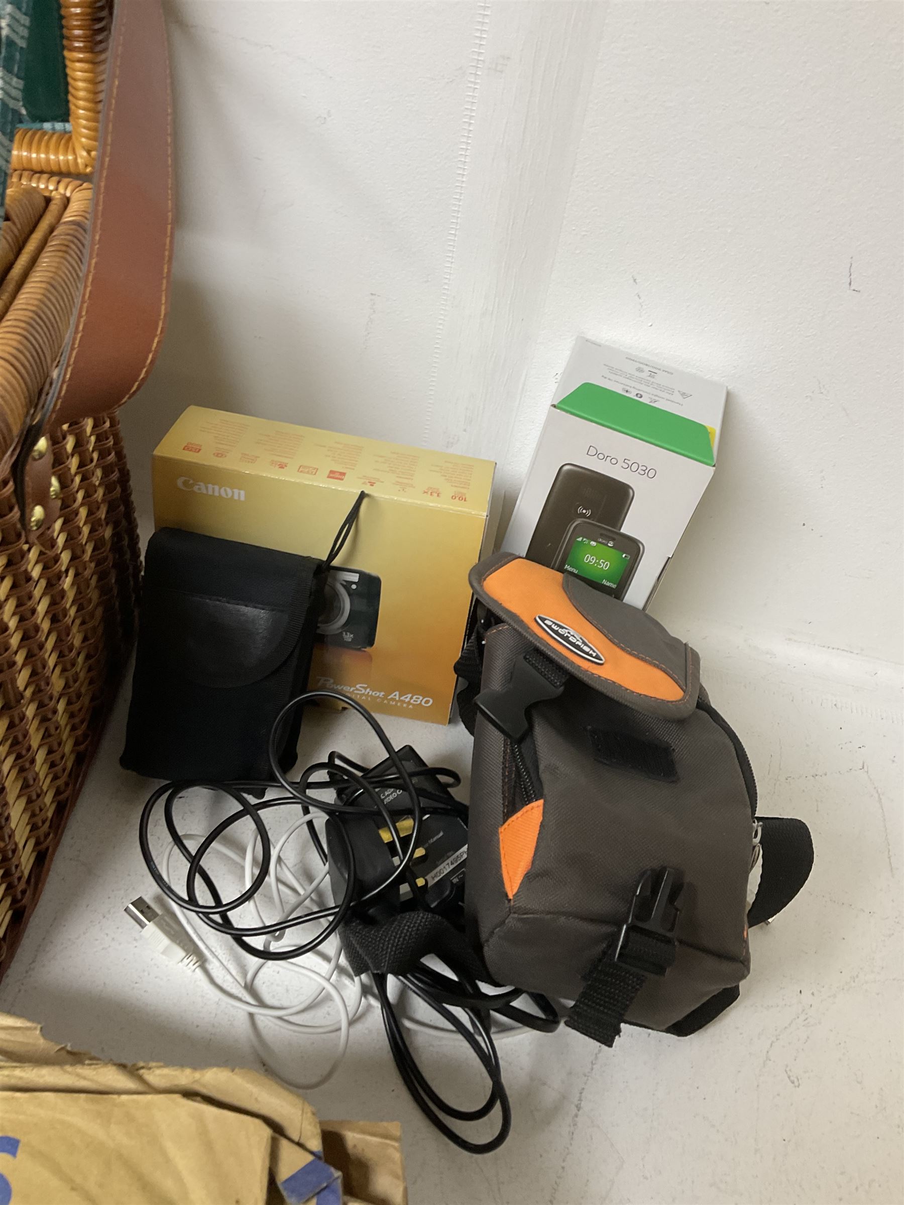 Canon Powershot A480 digital camera, in box, together with a Panasonic SDR-H86 digital video camera, Doro 5030 mobile phone, pair of Jessops Field Binoculars, two Weetabix diecast model cars, wicker picnic basket with plastic picnic ware and a collection of vinyl records