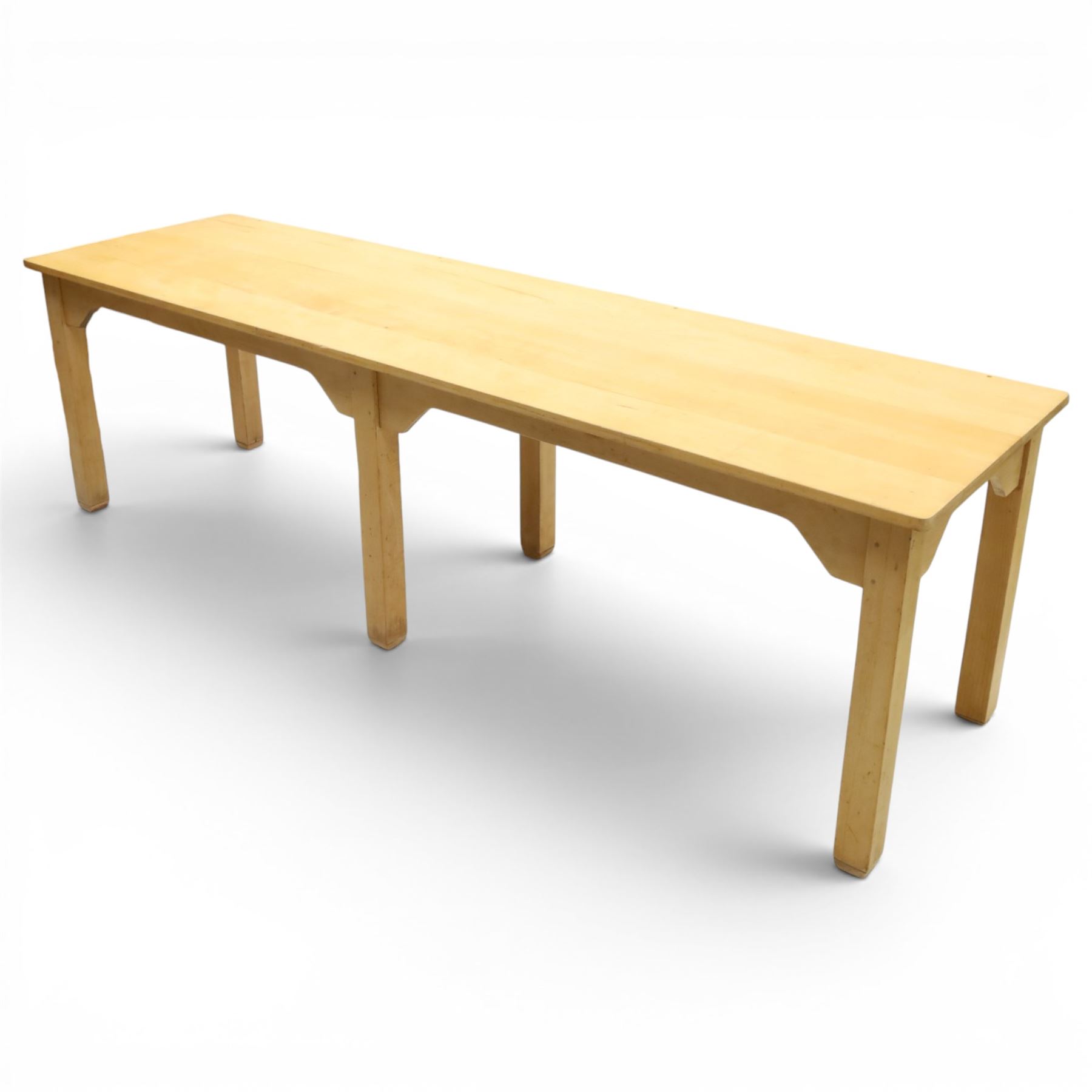 Mid 20th century beech dining table, rectangular top with rounded corners, plain apron with shaped brackets, raised on six square section supports