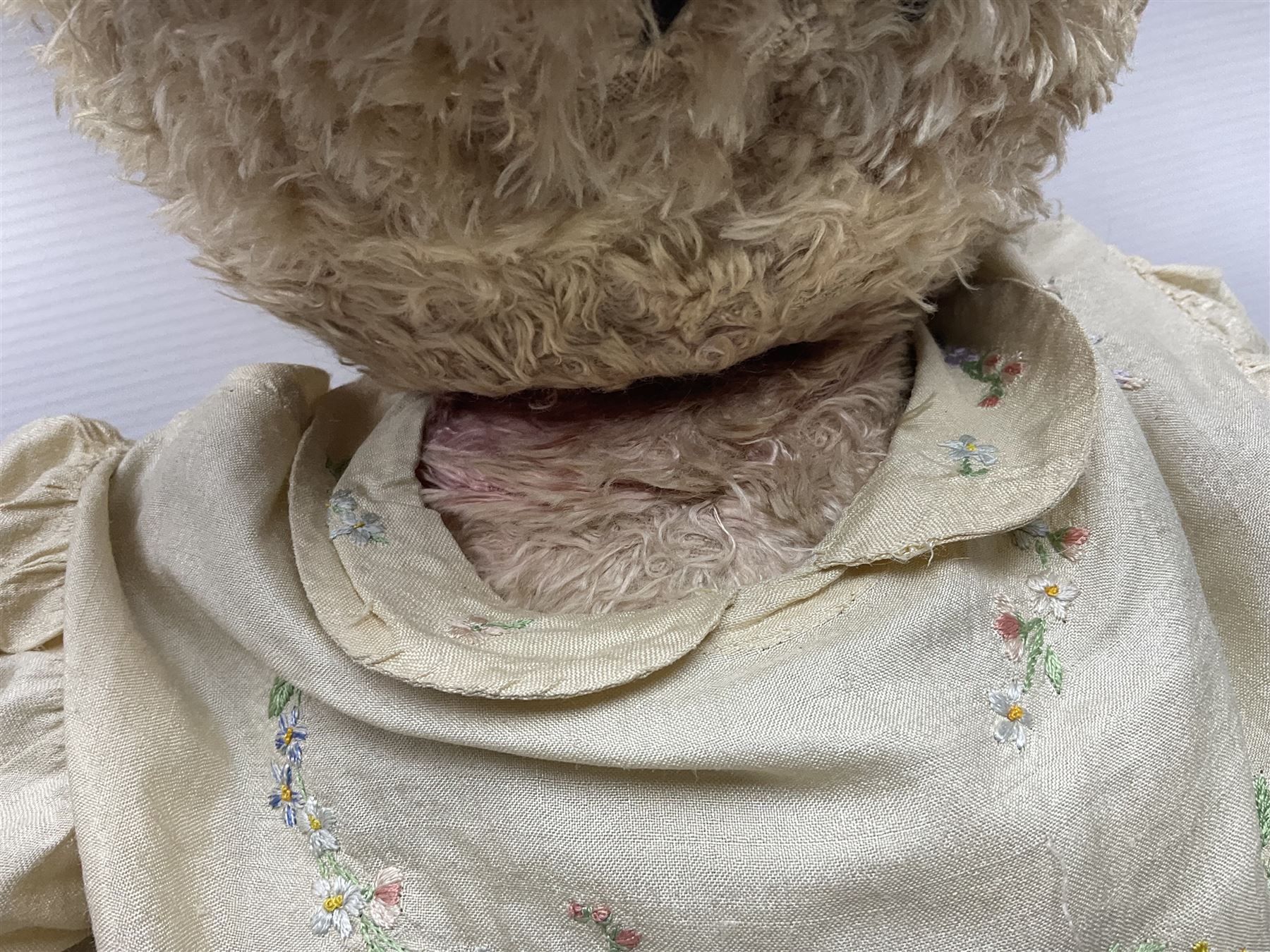 Two early 20th century straw filled jointed teddy bears, first example wearing a tweed jacket bearing Geoffrey Saville label, with leather padded paws and ears, horizontally stitched nose and humpback; second example with applied eyes, vertically stitched nose and faux leather paw pads, both with growler mechanisms, tallest H74cm 