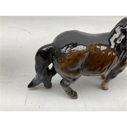 Four Beswick horses in bay, comprising rearing horse no.1014, Shetland pony no.1033, Shetland foal no.1034 and action Shire horse no.2578, all with printed or impressed marks beneath 
