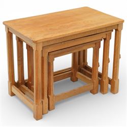 Mouseman - oak nest of three tables, raised on octagonal supports, with carved mouse signature, by the workshop of Robert Thompson of Kilburn