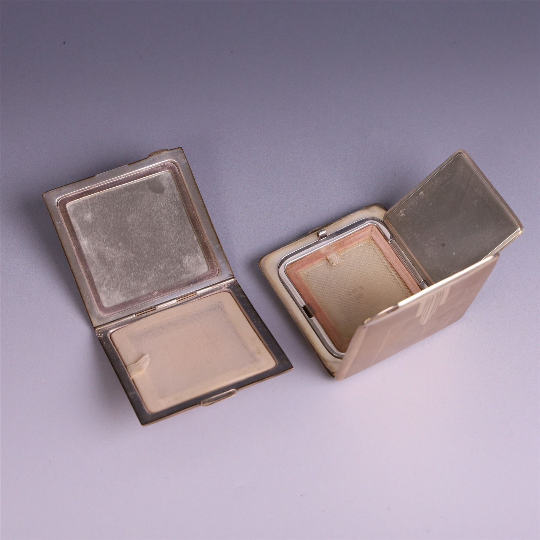 Two mid 20th century silver compacts, both rectangular with engine turned decoration, one with engraved monogram to cover, hallmarked Randle Brothers, Birmingham 1946, the other with personal engraving to interior, hallmarked William Suckling Ltd, Birmingham 1947, H7cm, both in fabric pouches
