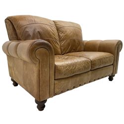 Three-seat sofa (W205cm, H95cm, D100cm); and matching two-seat sofa (W150cm); upholstered in stitched tan leather, on turned feet