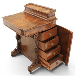 Victorian burr walnut Davenport, with hinged stationary top and slope, pull out writing surface with tooled green leather inset top, carved and turned front supports, flanked by two cupboard doors, raised on castors 