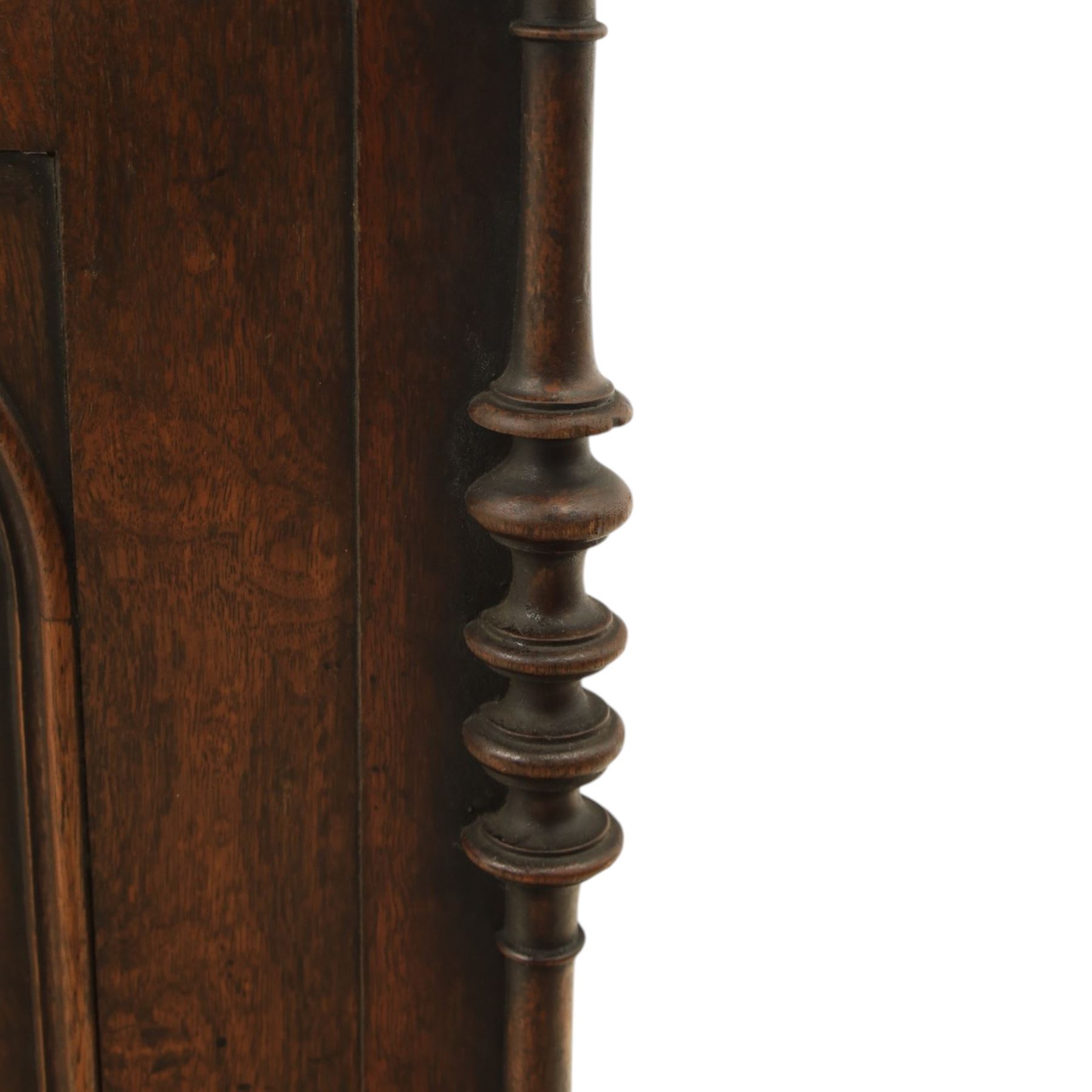 Victorian mahogany low cabinet, shaped rectangular top fitted with two arch panelled doors flanked by turned pilasters, enclosing two shelves and fitted with four short drawers with turned knobs 