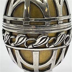 Modern silver limited edition Easter egg, no. 70/500, the gilded body decorated in relief with silver latticework and a band of flower heads, the detachable cover opening to reveal a gilt interior, each hallmarked St James House Company, London 1978, H5.5cm