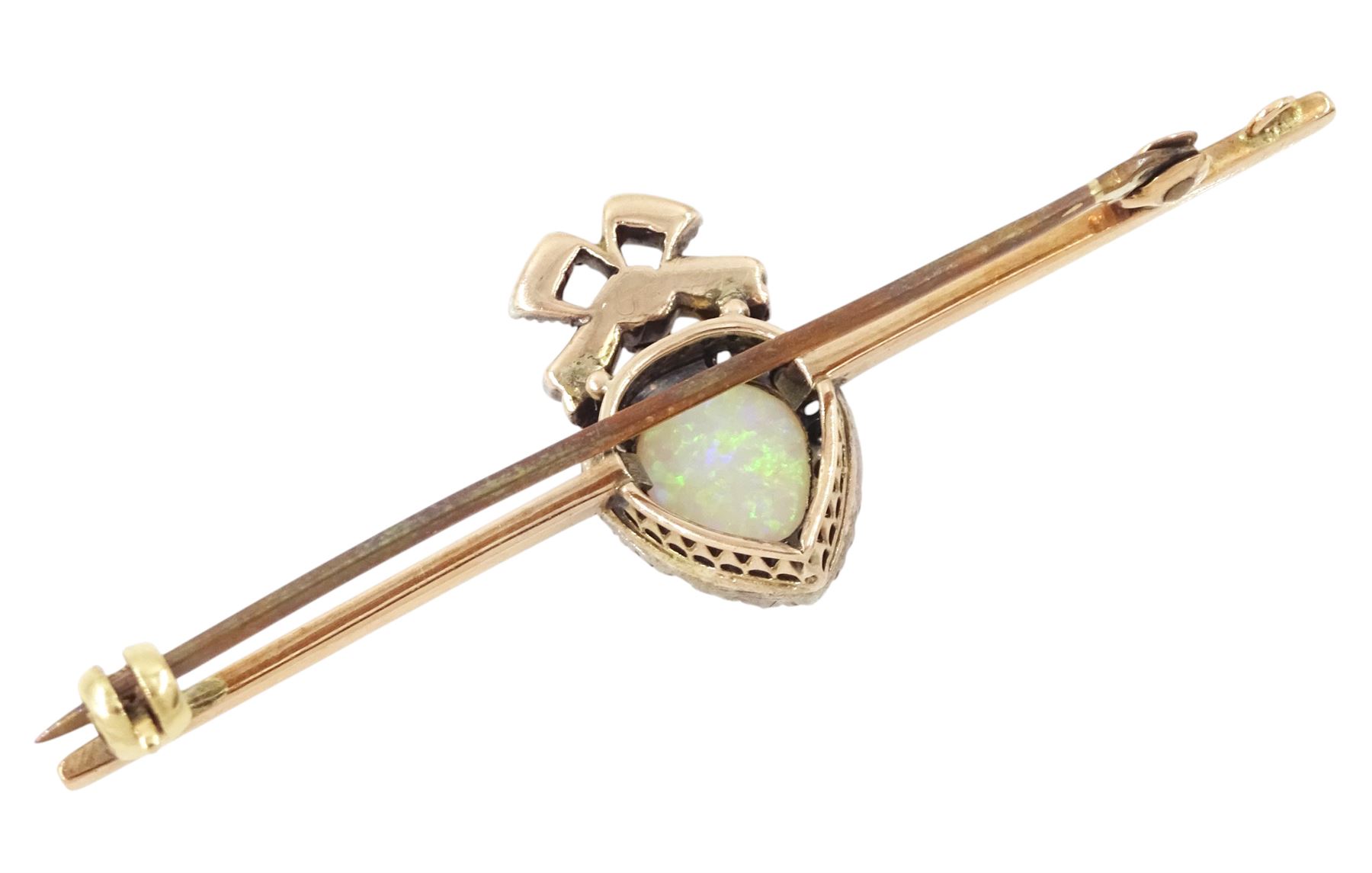 Edwardian gold and silver opal and diamond heart cluster brooch, central oval cut opal surrounded by rose cut diamonds, and surmounted by a diamond set ribbon bow