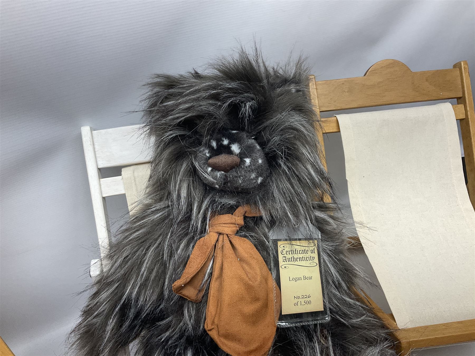 Charlie Bears bench, H41.5cm L58.5cm D29.5cm, and two Charlie Bears deck chairs, each approximately H37cm, together with a limited edition Silver Tag Bear, Logan Bear, 226/1,500, with tag, and two further bears, (6)