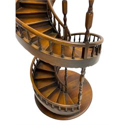 Miniature fruitwood spiral staircase, turned newel posts and balusters, rounded handrail, on circular moulded base