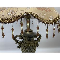 Pair bronzed amphora lamps with pineapple decoration, scroll handles and foliate base with scrolled feet together with pair peach ground shades and raised floral pattern H76cm (2)