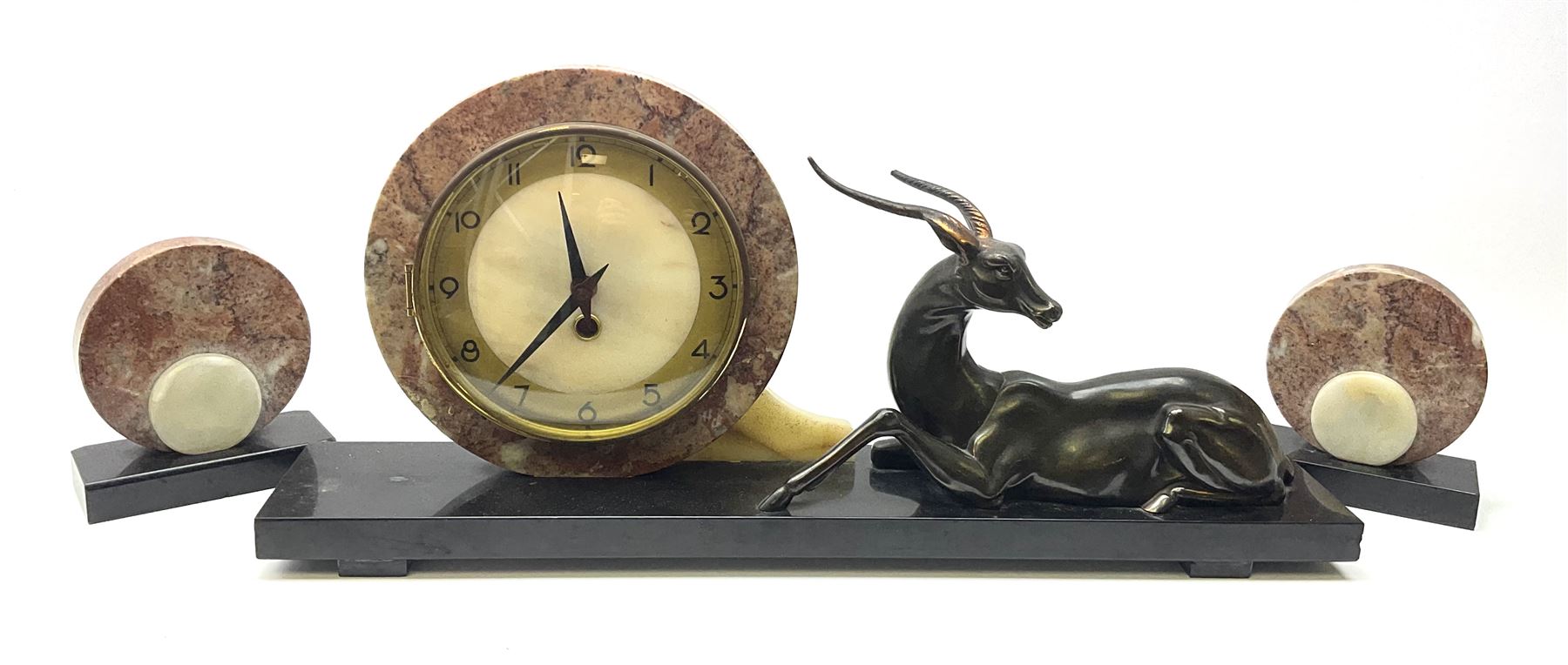 Art Deco style marble and anodised spelter three-piece clock garniture, model with recumbent gazelle, centre piece L52cm.  